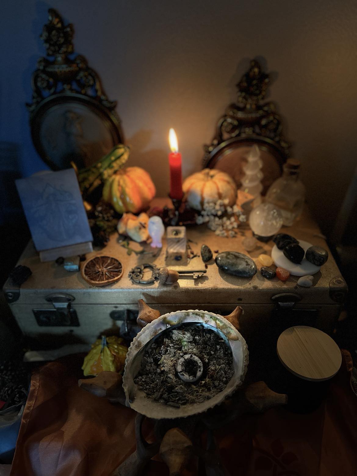Witchcraft altar with candles, crystals, and various Altar Tools and incense on the Altar.